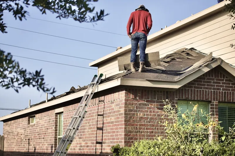 Professional roofer working on a residential roof in East Highland